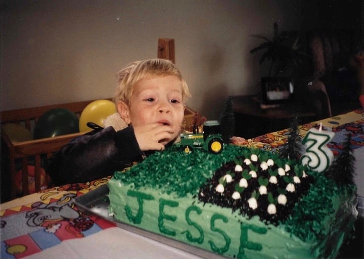 Jesse as a child on his birthday with a tractor cake