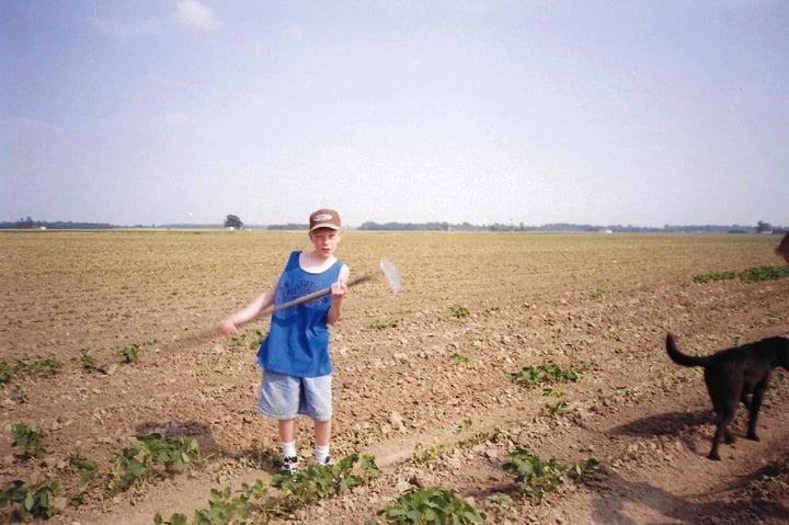 Jesse as a child hoeing his dad's field