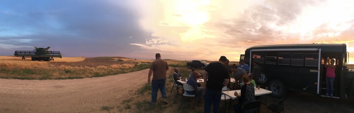 The Jessens and their employees gather for a field side dinner during wheat harvest