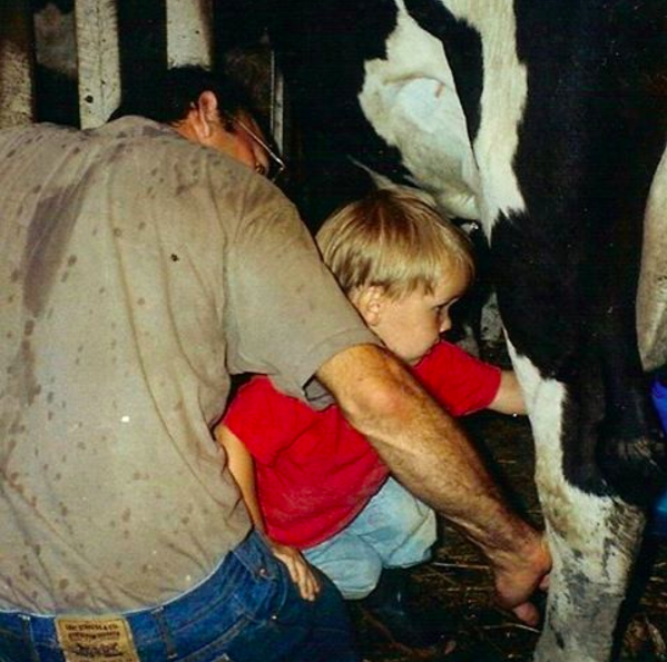 Me and my dad when I was a kid, milking a dairy cow