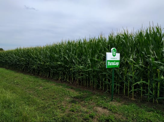 corn field with FarmLogs sign